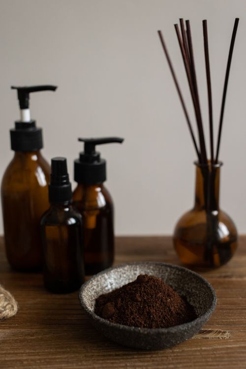 Free A serene setup of aromatherapy bottles, incense, and ground coffee in a rustic setting. Stock Photo