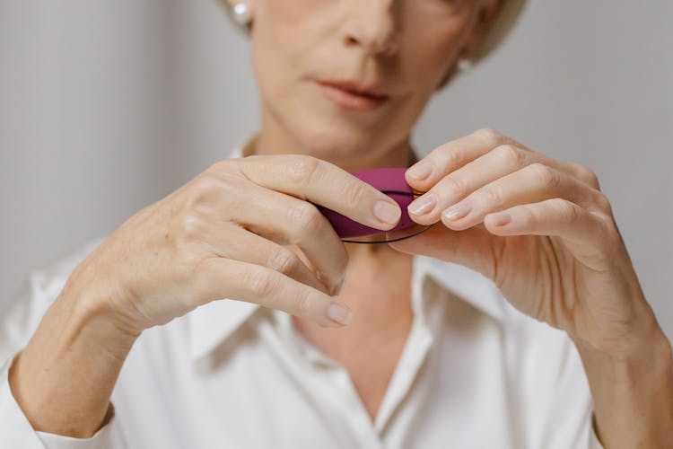 Woman Holding Purple Thing In Hands