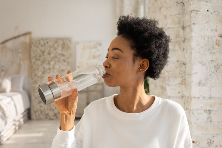 Woman Drinking Water From A Bottle