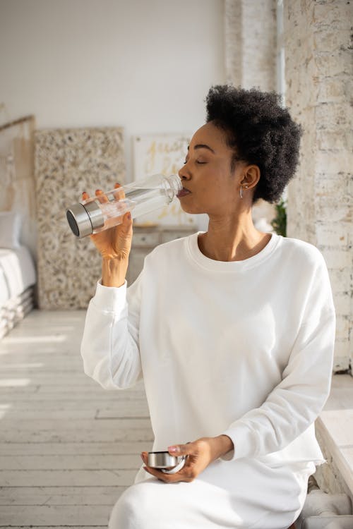 Free Woman Drinking Water from the Bottle Stock Photo
