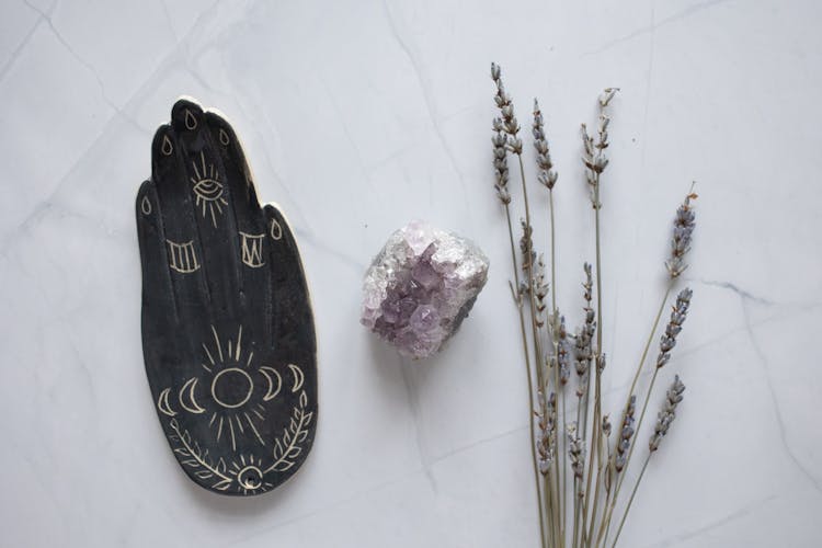 Decorative Plate, A Crystal And Dried Plants On A Table