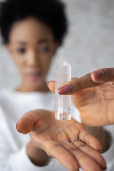 Woman displaying a clear quartz crystal, emphasizing healing and mindfulness.