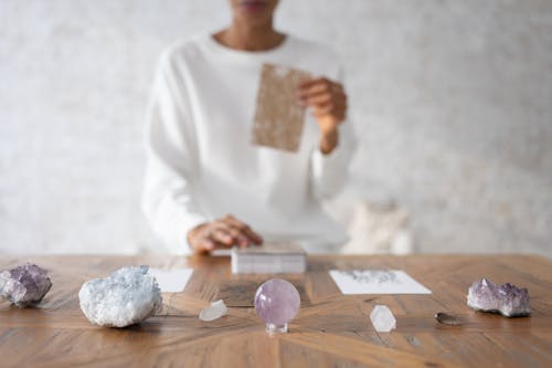 Person Arranging Cards at Small Exhibition of Minerals and Rocks