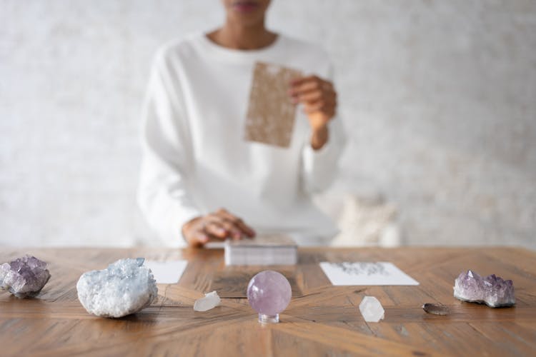 Person Arranging Cards At Small Exhibition Of Minerals And Rocks