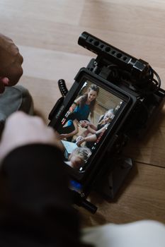 Close-up of a video monitor showing people having a good time indoors.