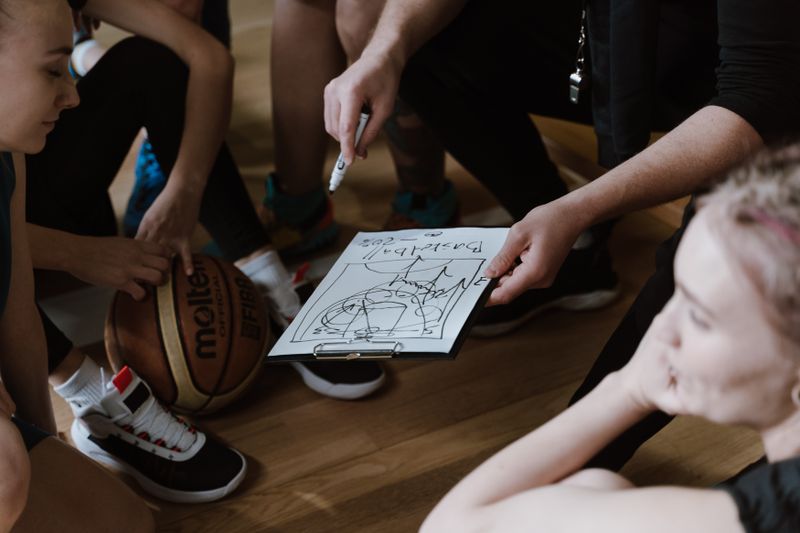 Coach planning tactics with team