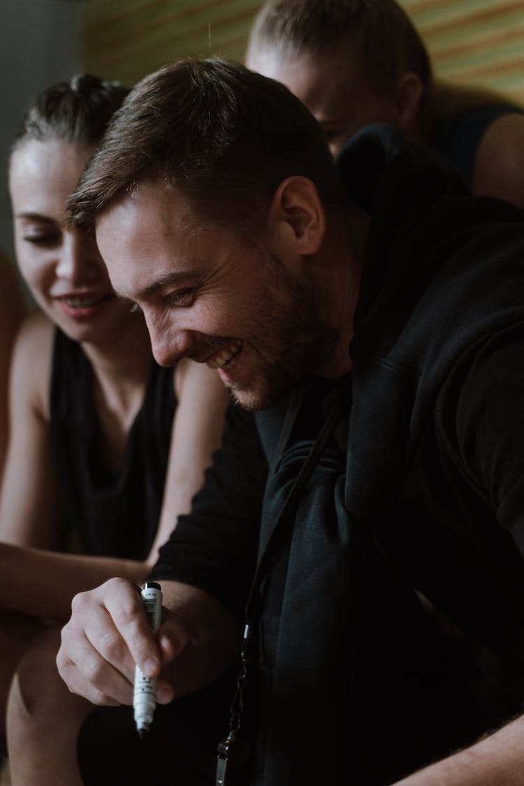 A Happy Bearded Man Holding A Marker