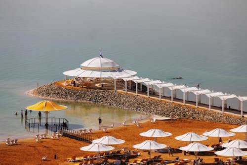 White Canopy on the Beach Beside the Umbrellas