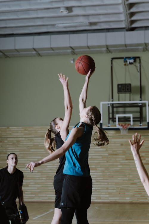 Free Woman in Black Tank Top Holding Basketball Stock Photo