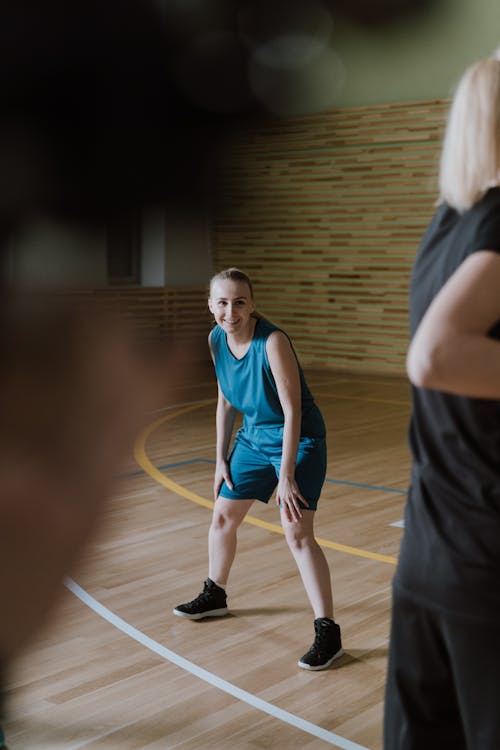 A Woman Wearing Jersey on the Wooden Court