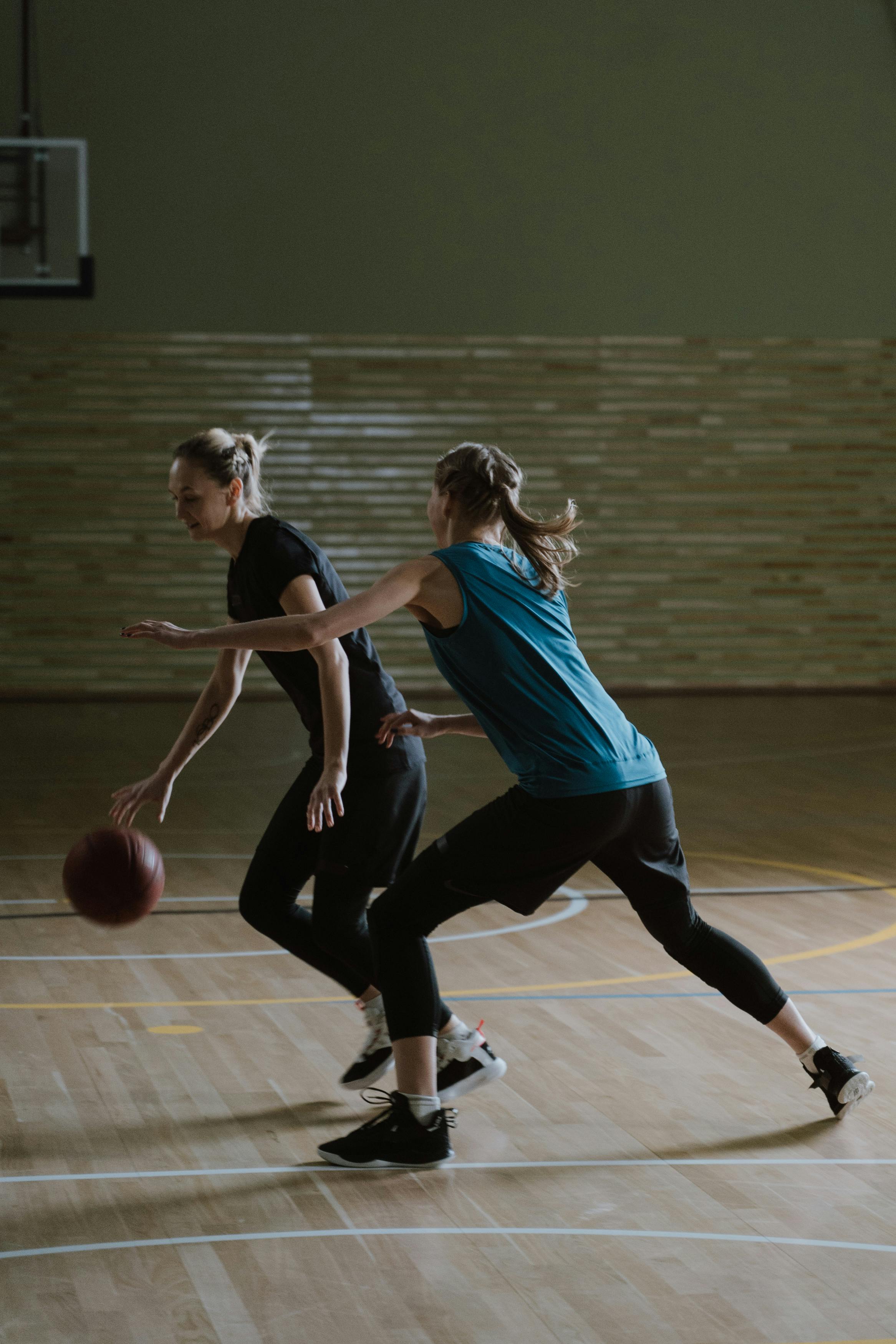 two women playing basketball