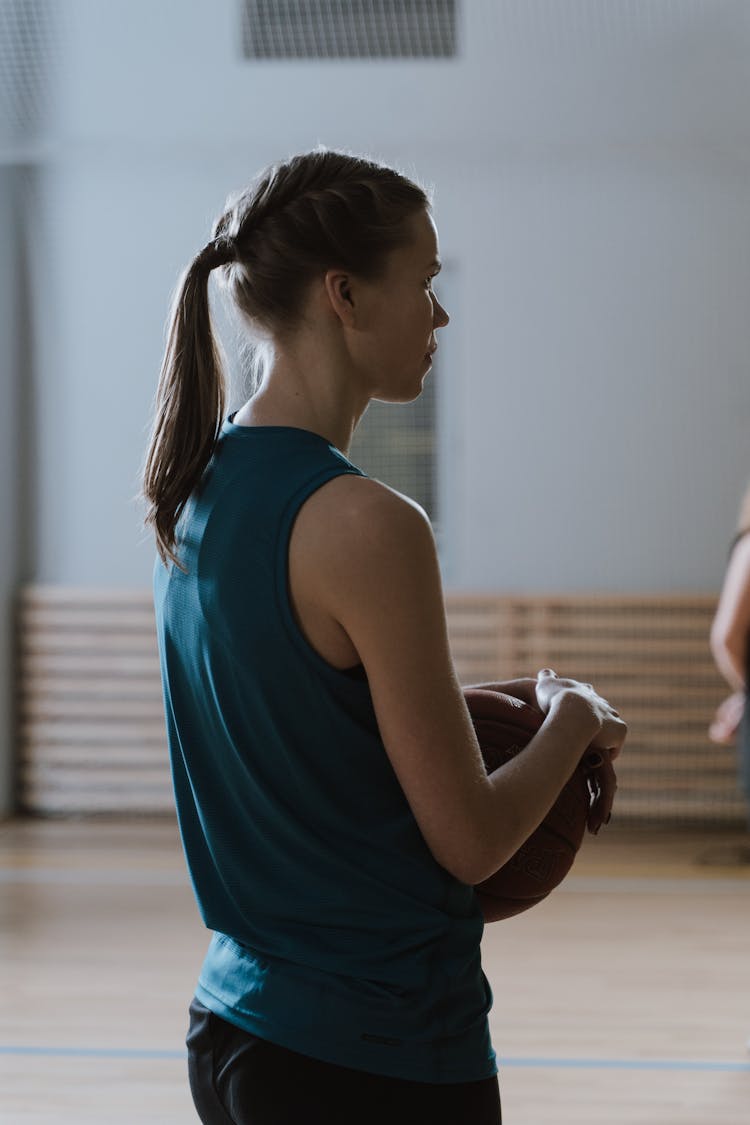 A Woman Holding A Basketball 