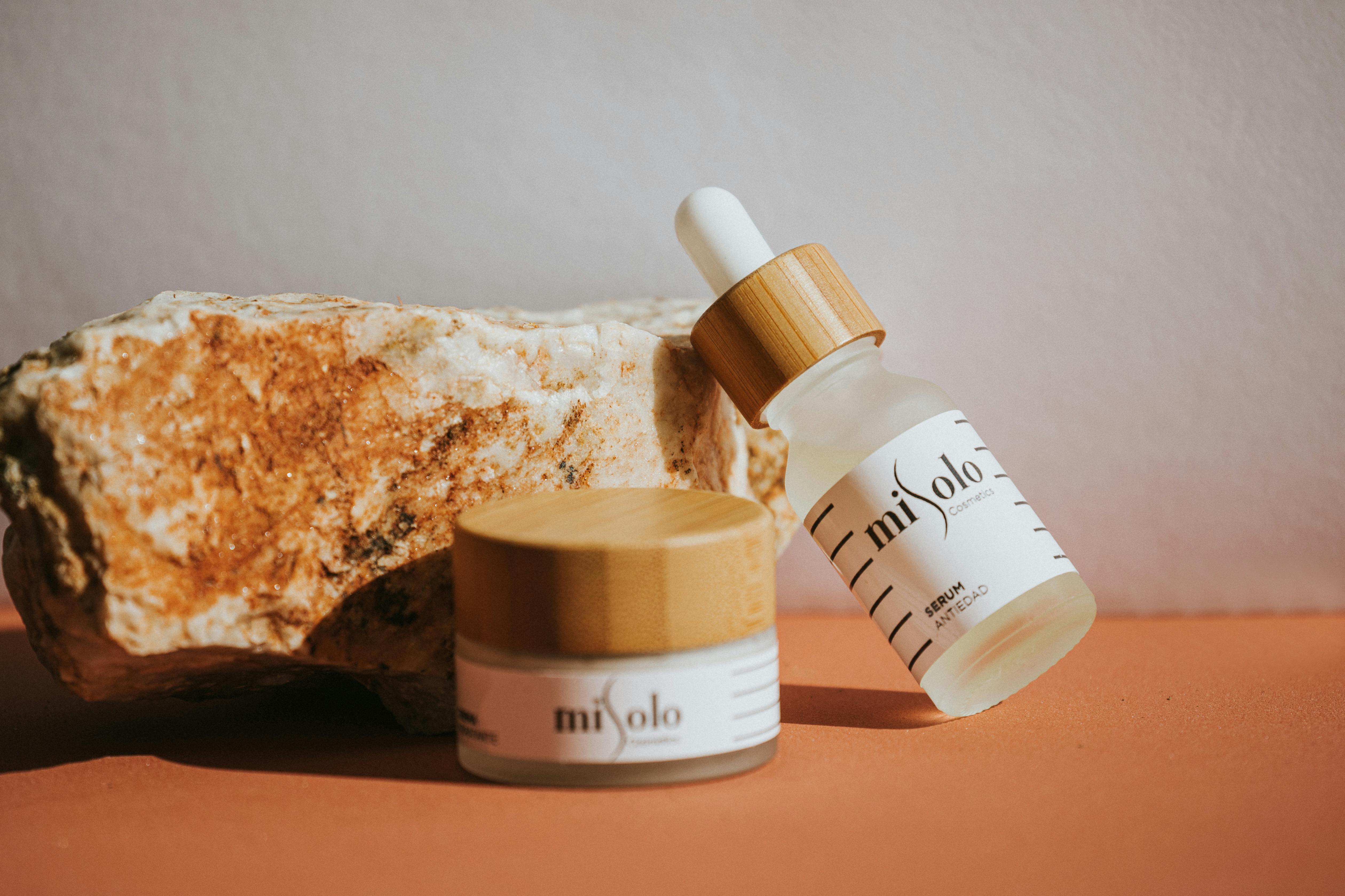 Elegant skincare products displayed with an earthy stone background for a natural feel.