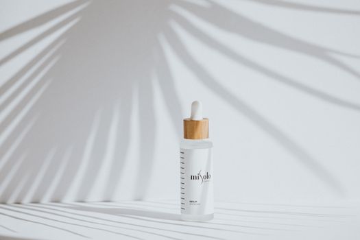 Elegant cosmetic product bottle casting shadows, perfect for skincare branding.