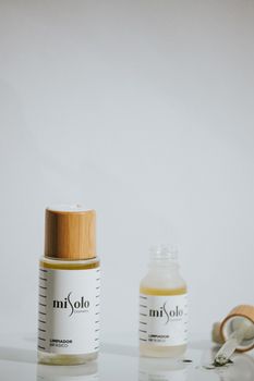 Minimalist skincare product bottles with natural elements on a clean background, emphasizing elegance.