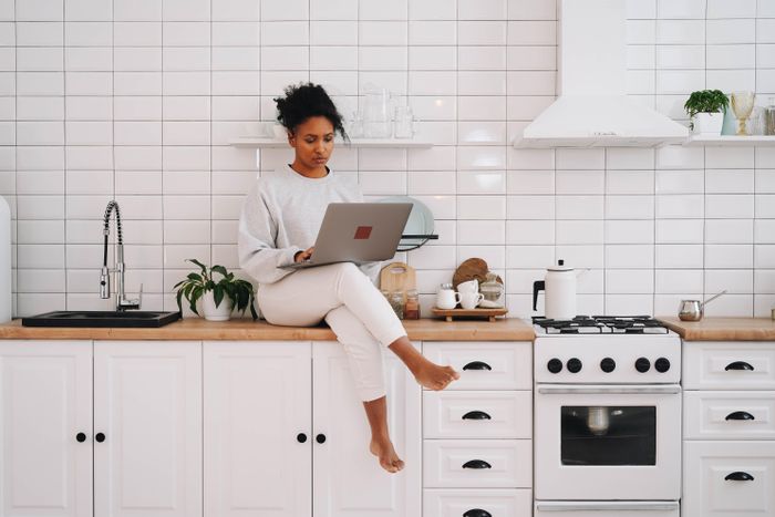 Person working on a laptop in a bright kitchen — photo by olia danilevich on Pexels