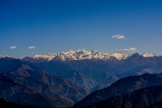 Breathtaking view of the majestic snow-capped Himalayan mountains under a clear blue sky.