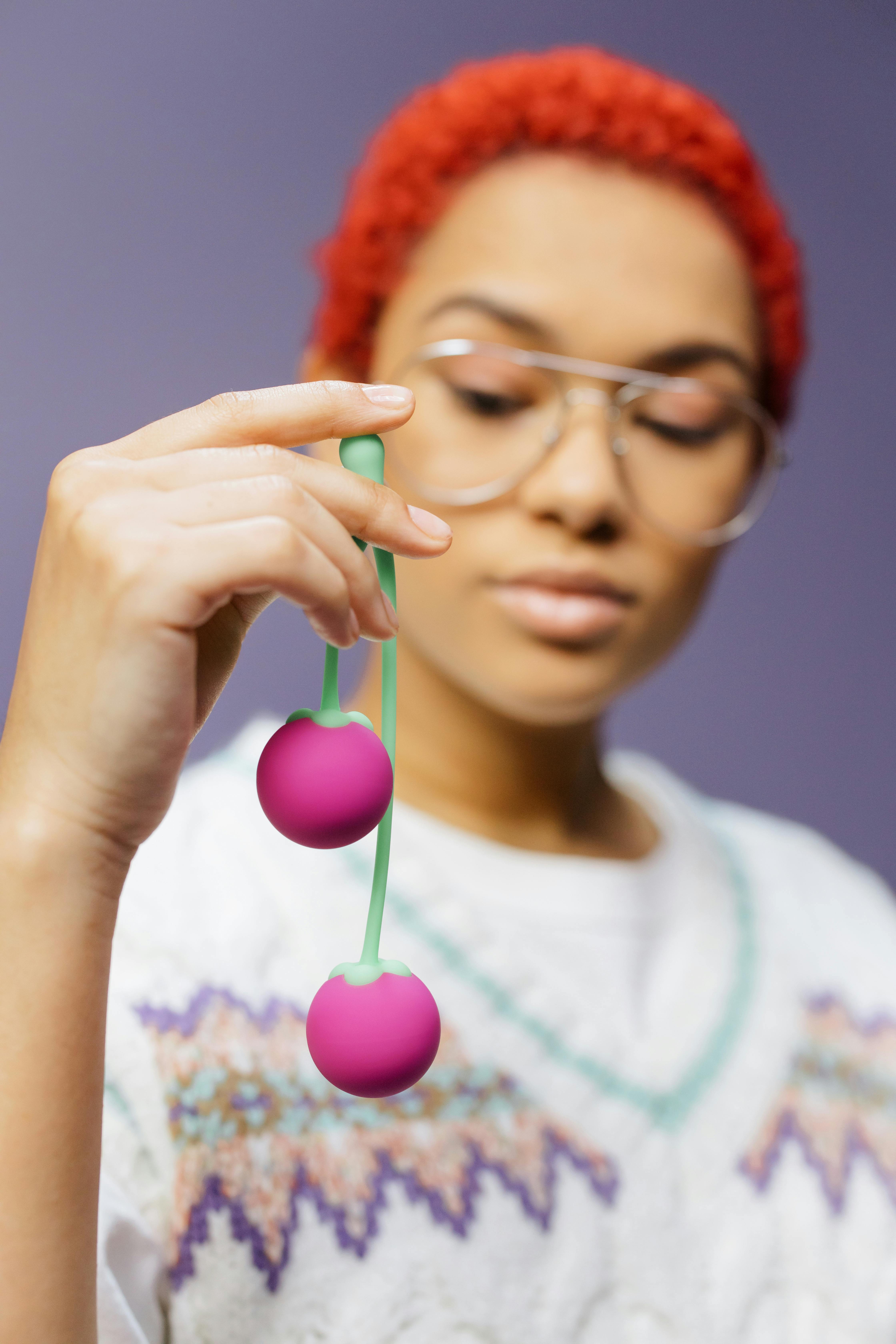 a woman holding adult toys