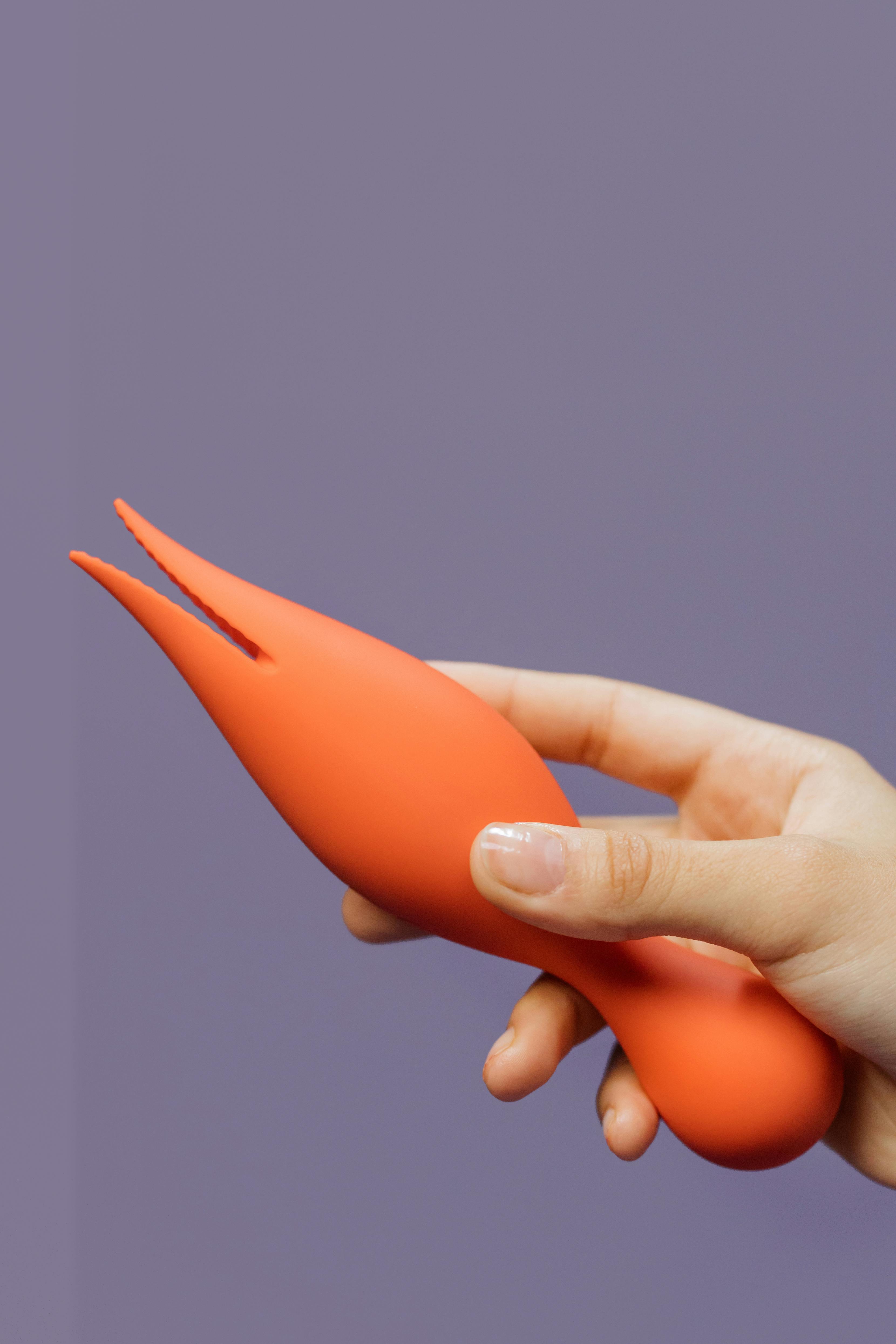 close up shot of a person holding an adult toy