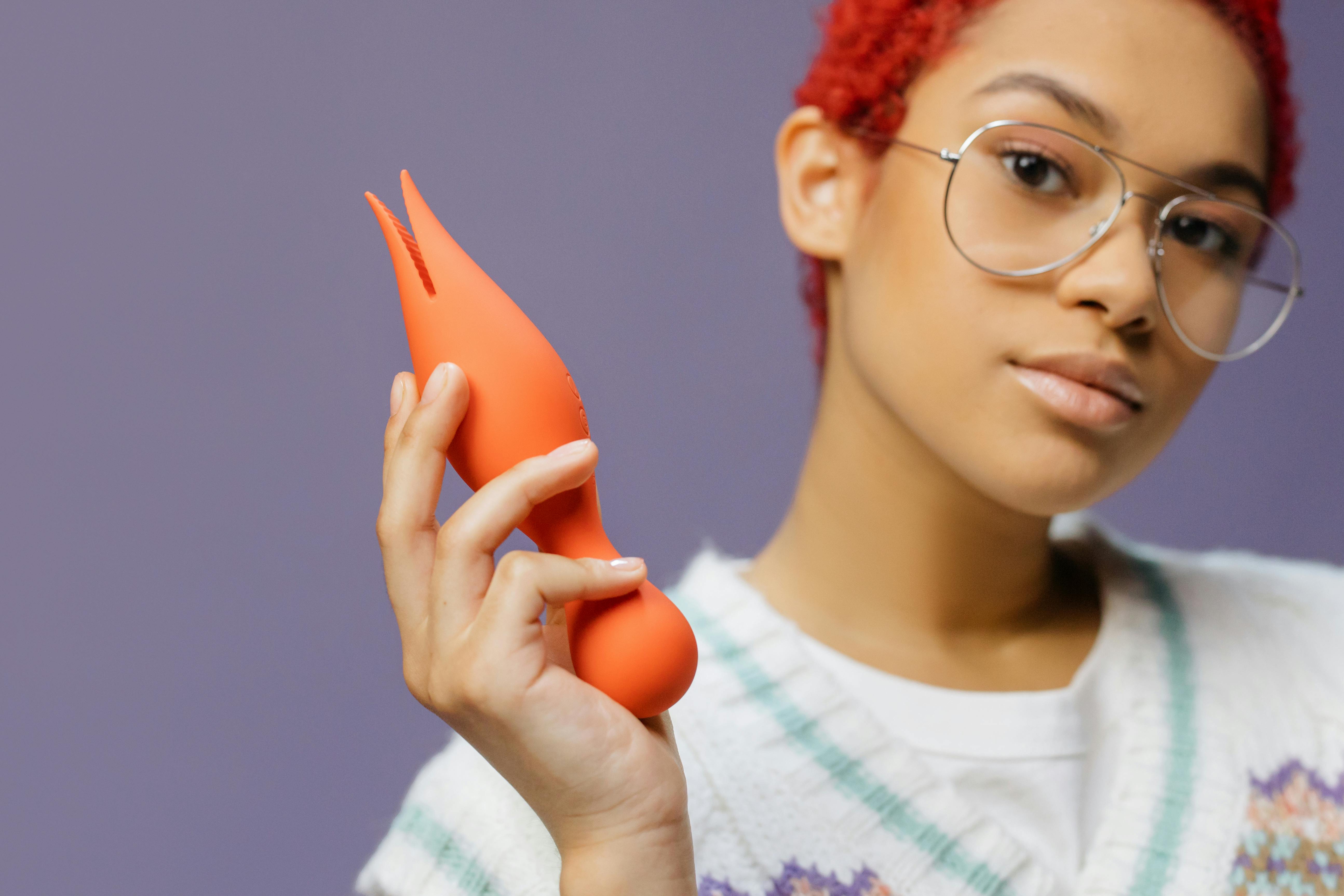 a woman holding an adult toy