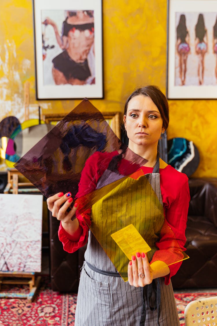 Woman In An Apron Holding A Colorful Glass Panes