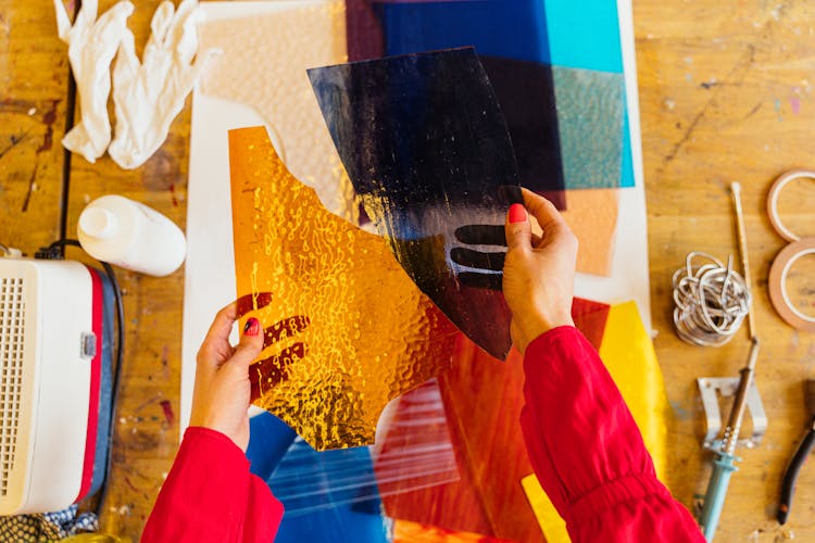 Hands Holding Pieces Of Stained Glass