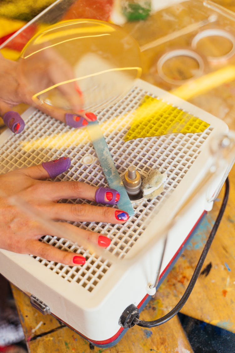 Hands Milling Piece Of Plastic