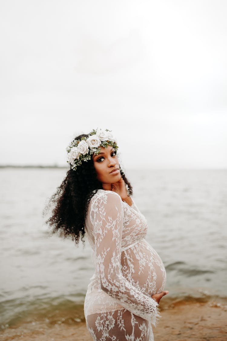 Gentle Pregnant Black Woman In Lace Dress On Shore