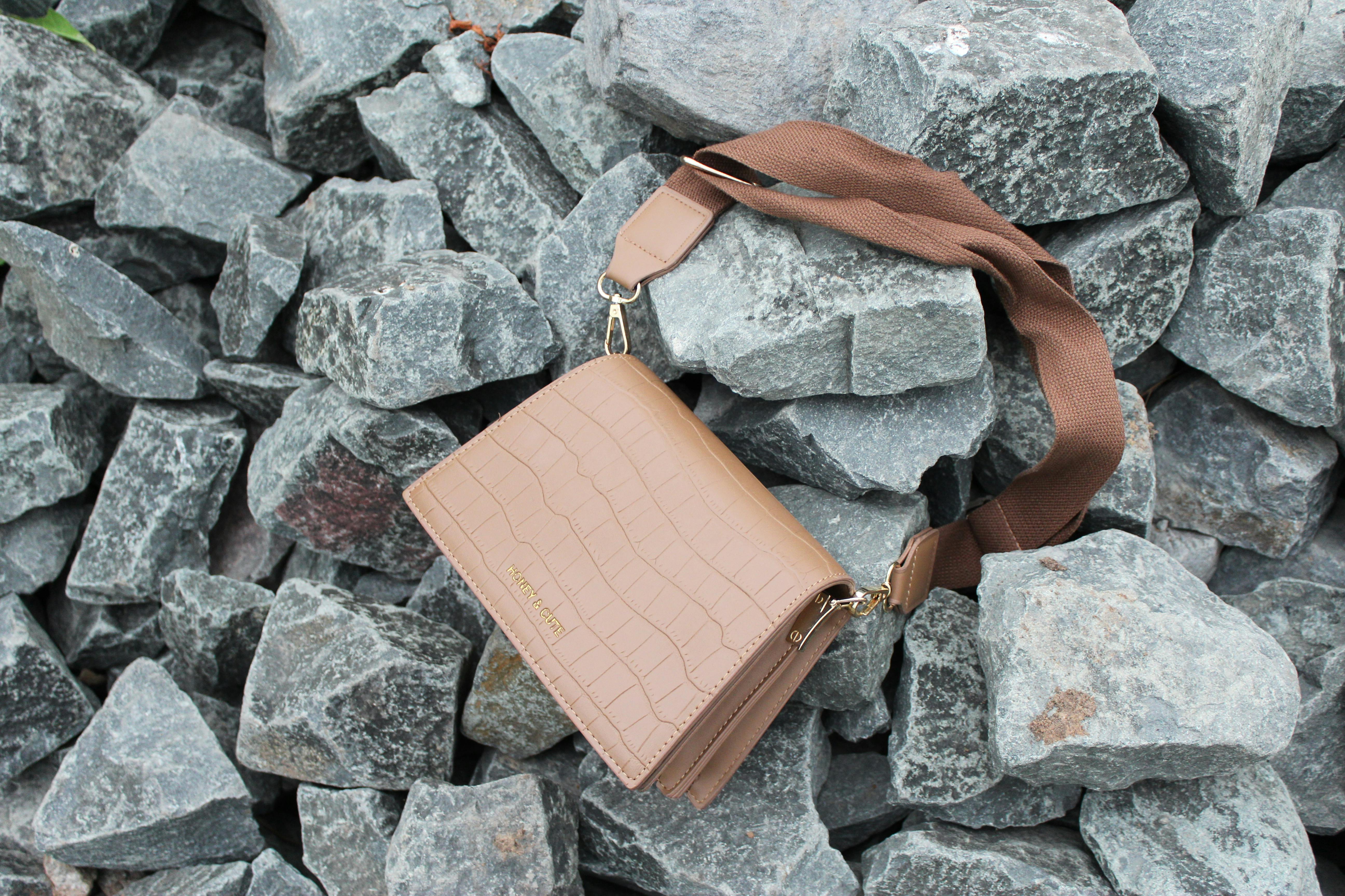 Free stock photo of bag, leather bag, stones