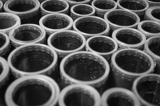 Detailed black and white photograph showing a close-up view of vintage film rolls with a retro feel.