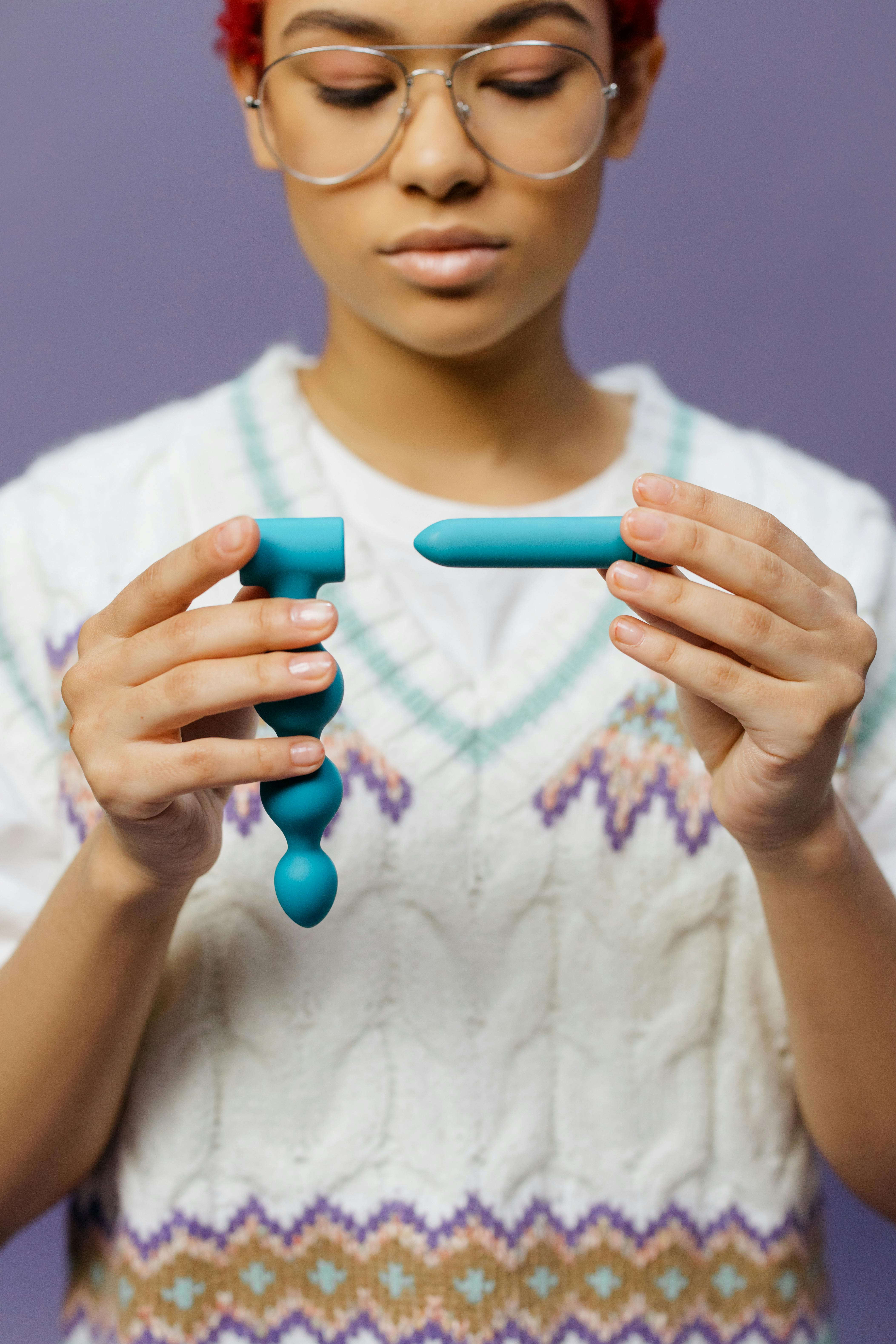 a woman holding adult toys