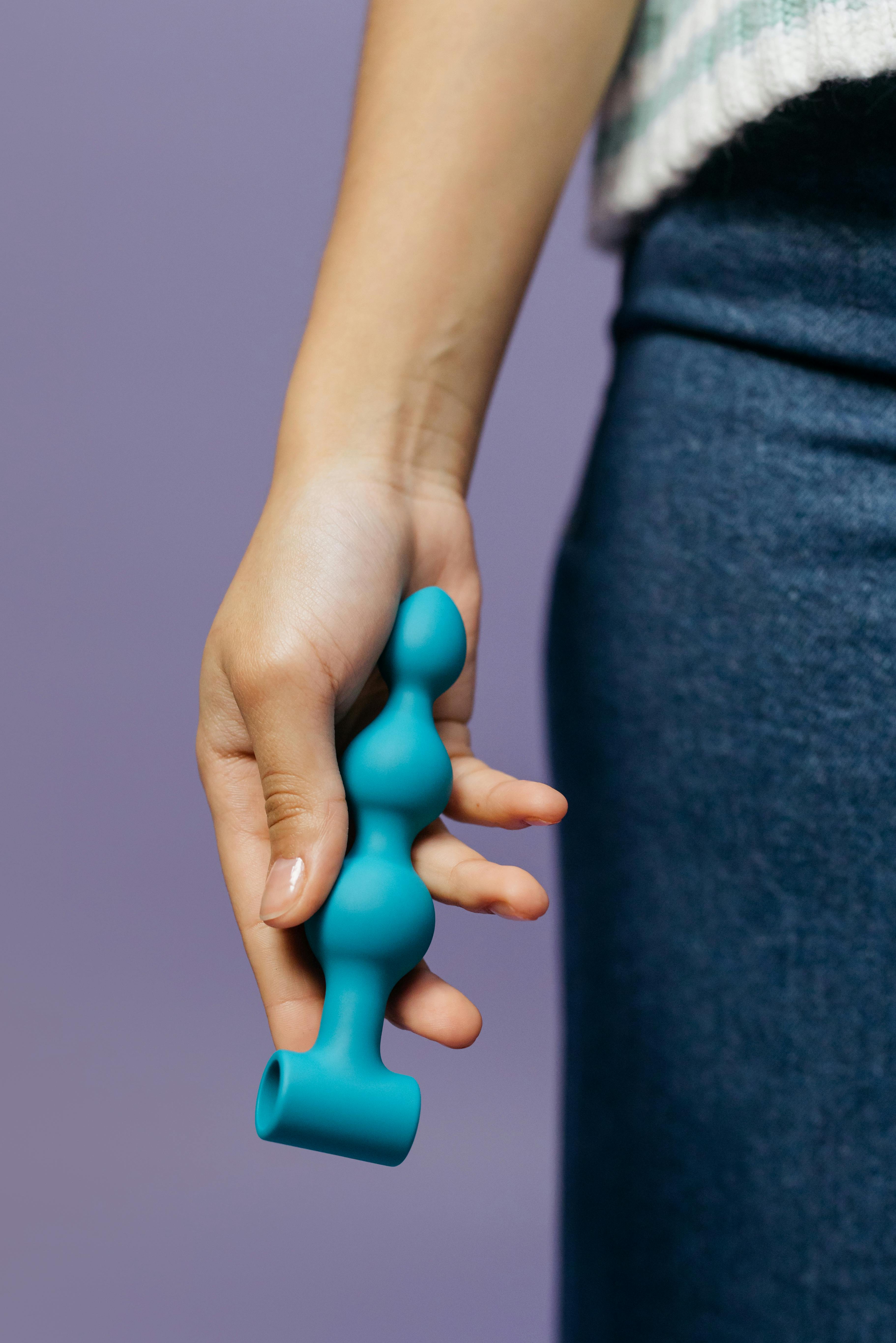 close up shot of a person holding an adult toy