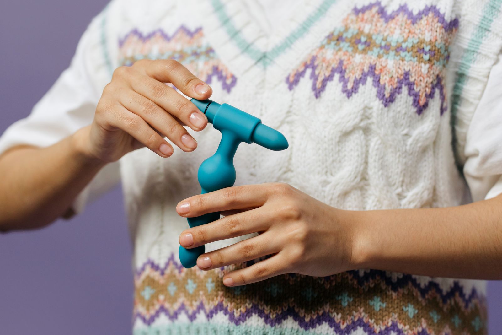 Personal wellness device shown in a tasteful product-handling photograph