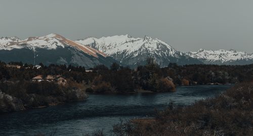 Free Stunning view of snowy mountains and tranquil lake in a serene natural setting, ideal for nature enthusiasts. Stock Photo