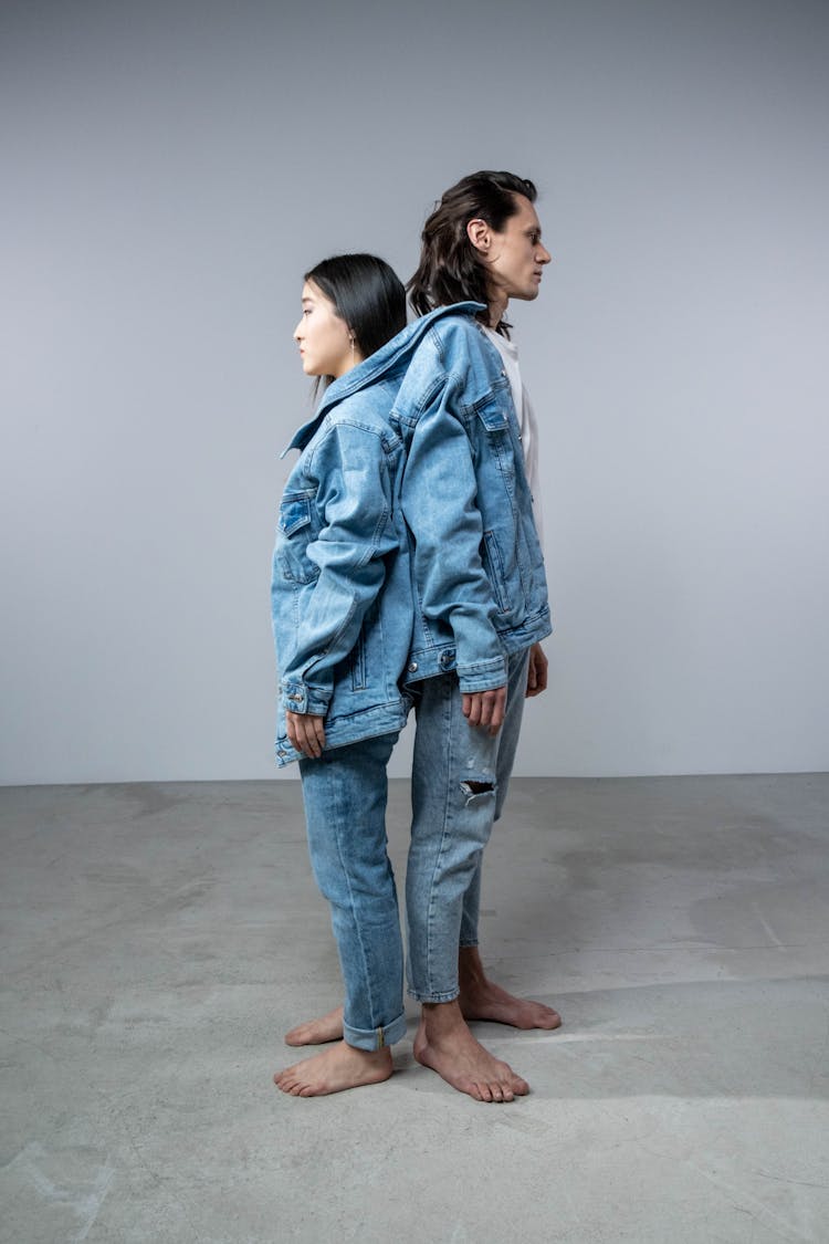 A Man And Woman In Denim Jackets