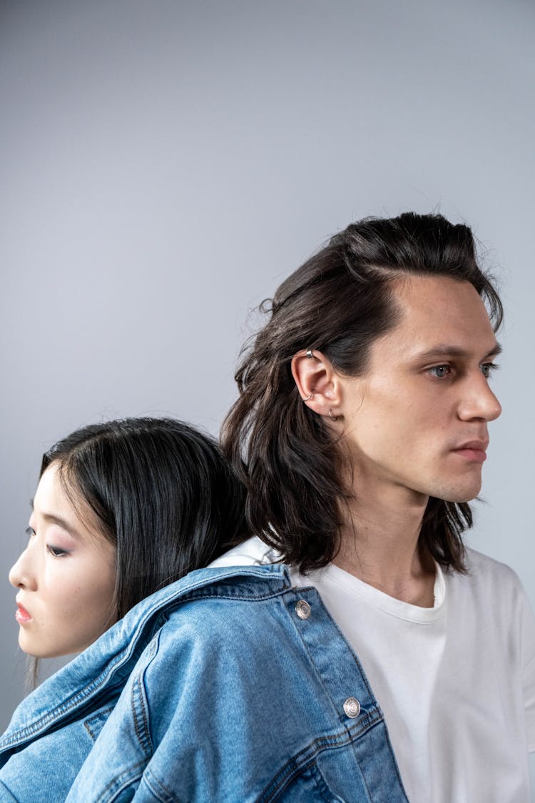 A Man And Woman In Denim Jackets