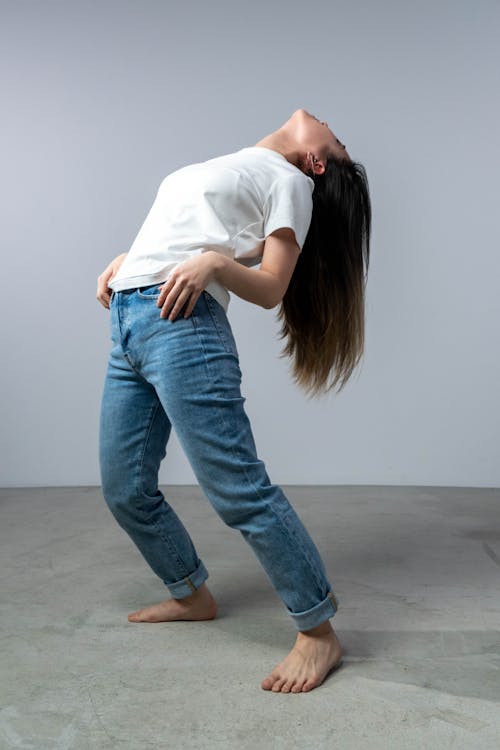 Woman in White T-shirt and Blue Denim Jeans