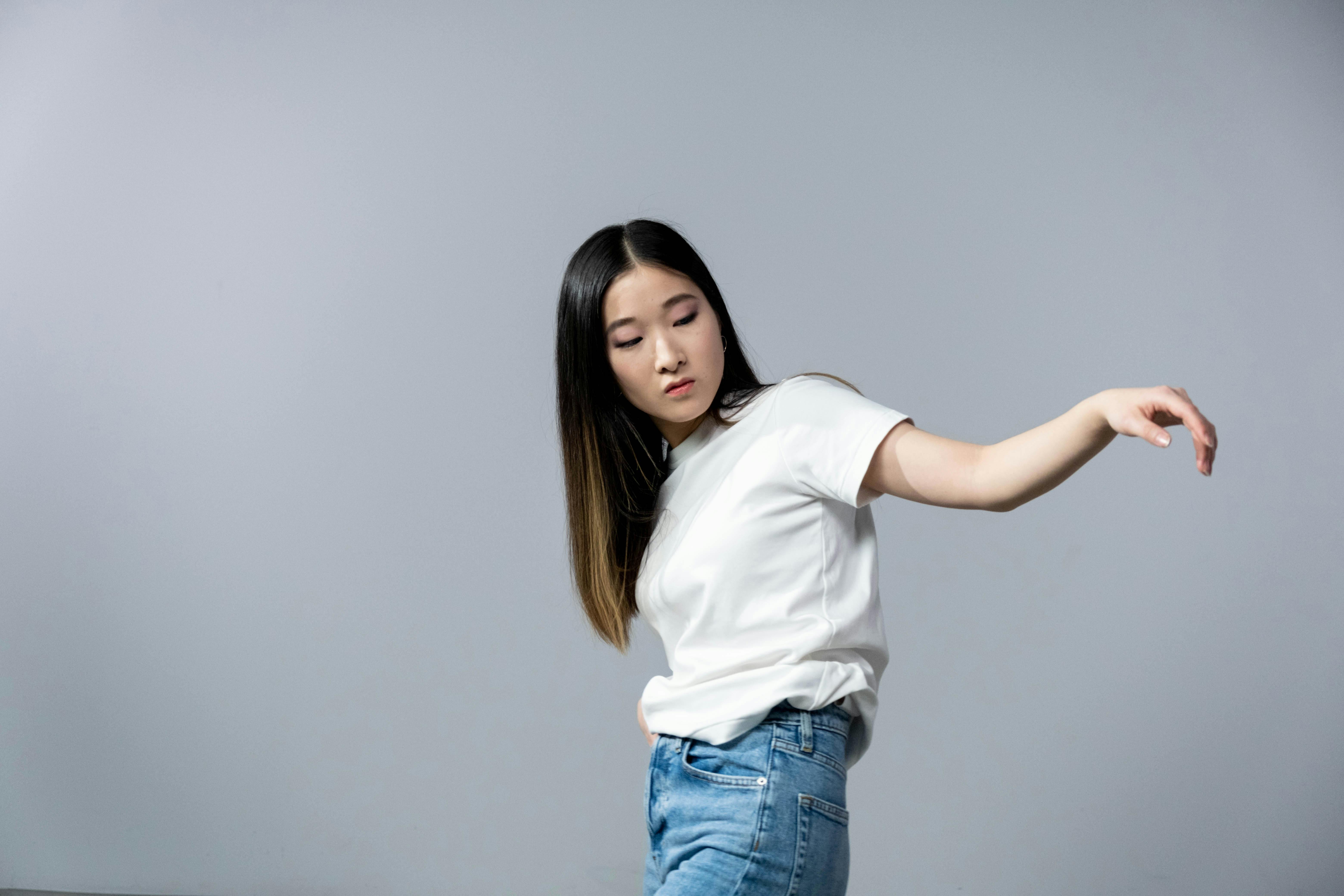 Woman in Black Tank Top and Blue Denim Jeans Sitting on Black Chair · Free  Stock Photo