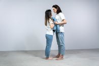 Man and Woman Standing Holding a Denim Jacket