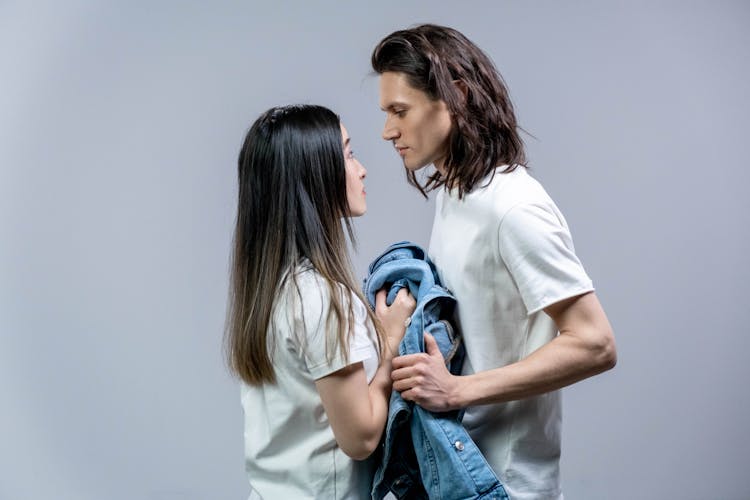 Man And Woman Holding A Denim Jacket