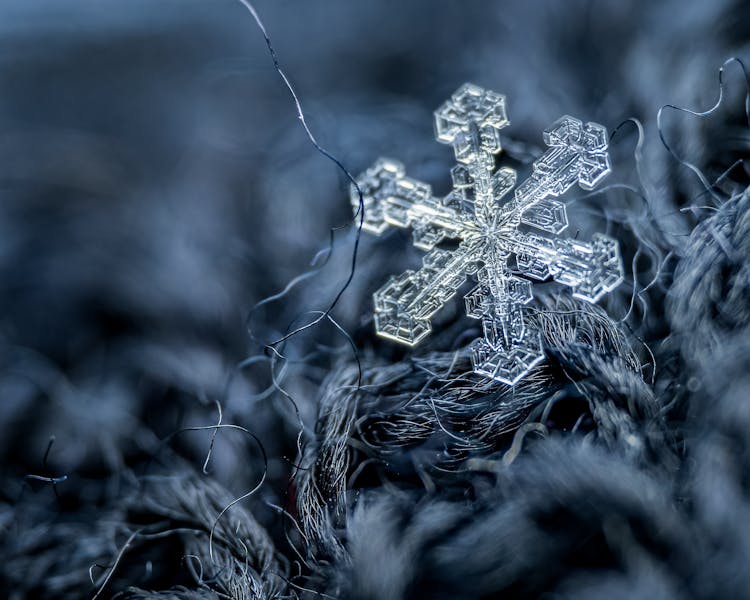 Small Snowflake On Woolen Surface With Fiber