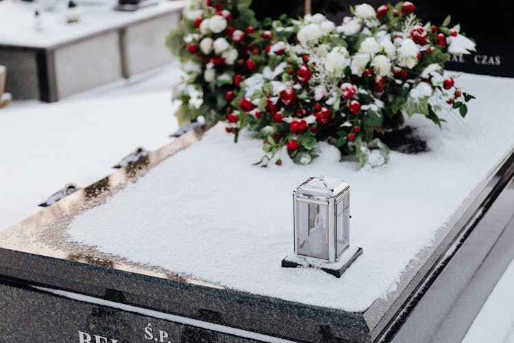 Vigil Light On Snow Covered Tombs