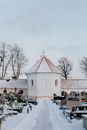Snow Covered Pathway Leading to the Chapel in a Cemetery