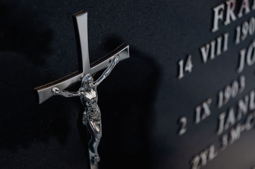 Free Detailed photo of a cross on a tombstone featuring engraved text, representing religious themes. Stock Photo