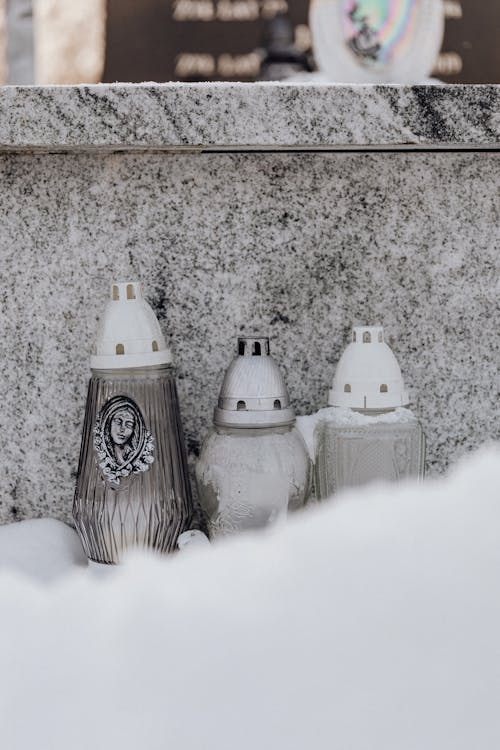 Candle  Containers on Snow Covered Grave