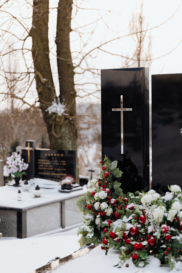 Floral Arrangements On Tombs With Snow