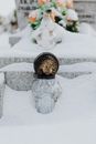 A Glass Candle Holder on Snow Covered Ground