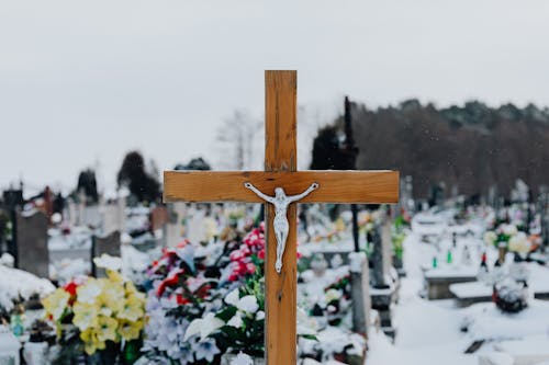 A Wooden Cross in a Cemetery