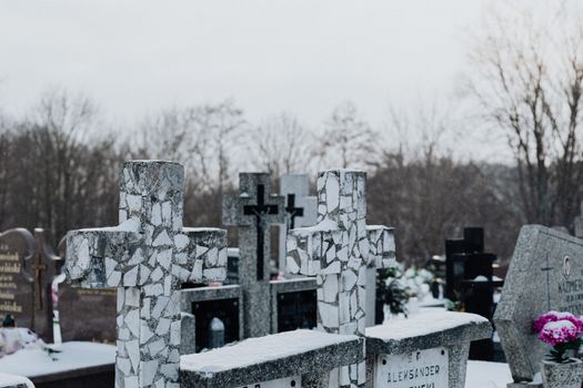 Cross Gravestones with Snow in a Cemetery
