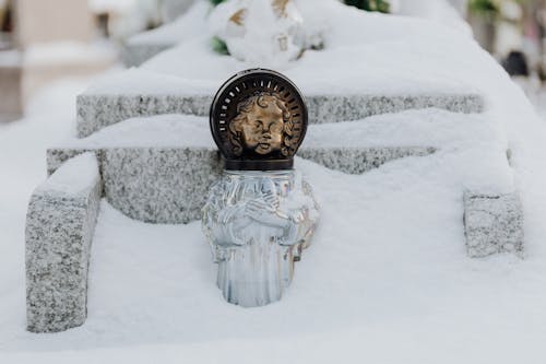 A Glass Bottle on Snow Covered Ground